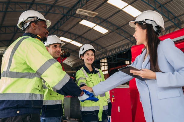 istock A group of workers in safety gear are shaking hands 2164315260