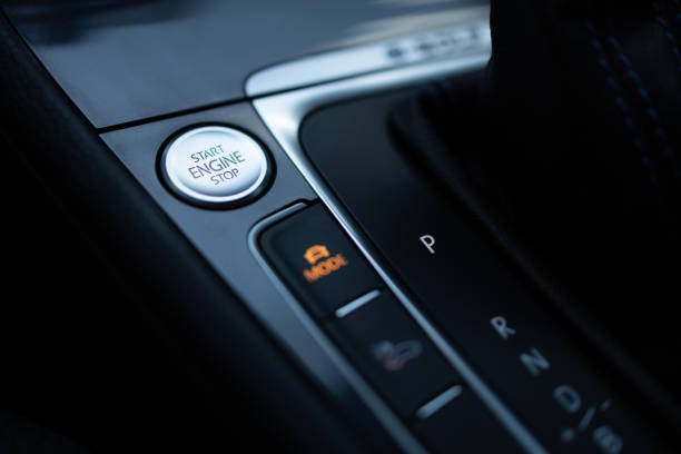 istock Start-stop buttons on modern cars selective focus. Silver start and stop button. Automatic electric car 2164315786