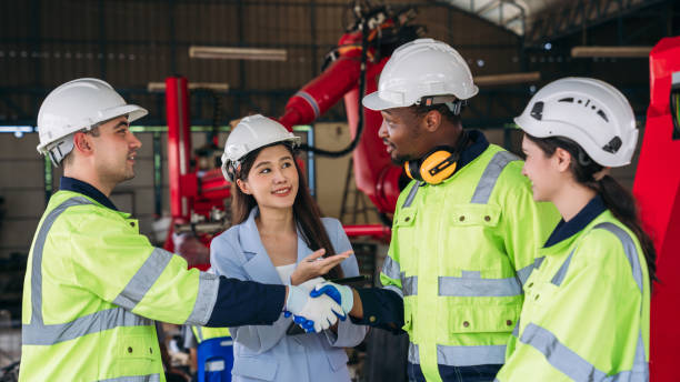 istock A group of workers wearing safety gear. Worker industry join hand for collaboration. 2164316488