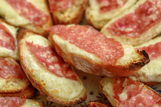 Bruschetta with mozzarella and salami isolated on plate closeup