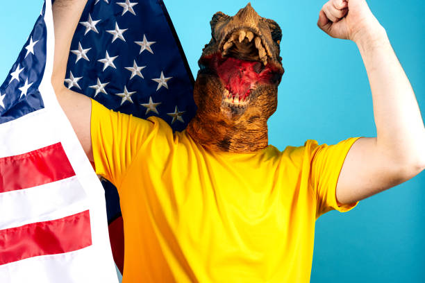 istock Enthusiastic Dinosaur Costume Enthusiast Celebrates National Pride Vibrantly 2164317723