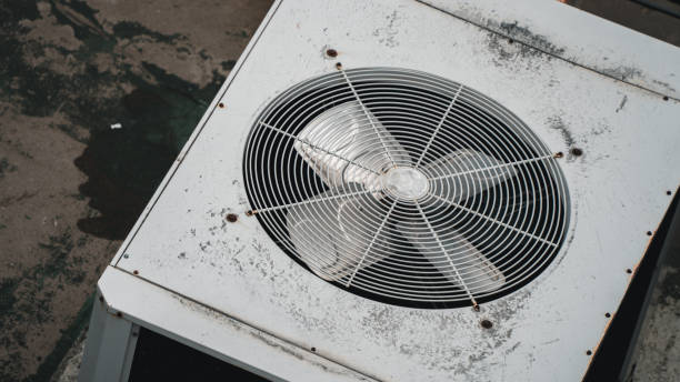 istock Air conditioner compressor on a building's rooftop, accompanied by industrial air conditioning units and ventilation systems. 2164319983