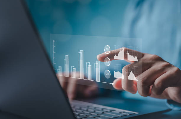 istock Finance and return on investment concept. Man touching on a virtual screen of data and charts, investments analysis in assets and financial growth graphs, business strategy analysis, and marketing. 2164322506