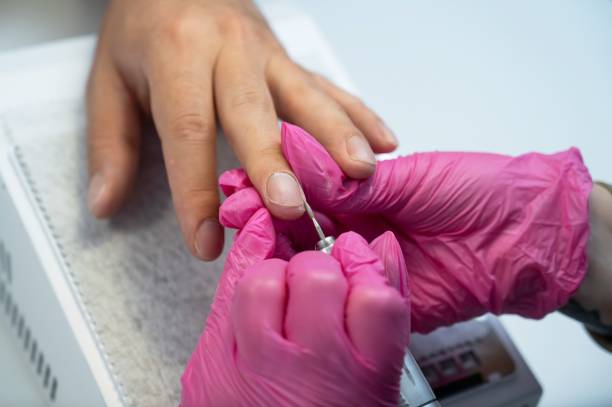 istock The master makes a hardware manicure to a male client. 2164323487