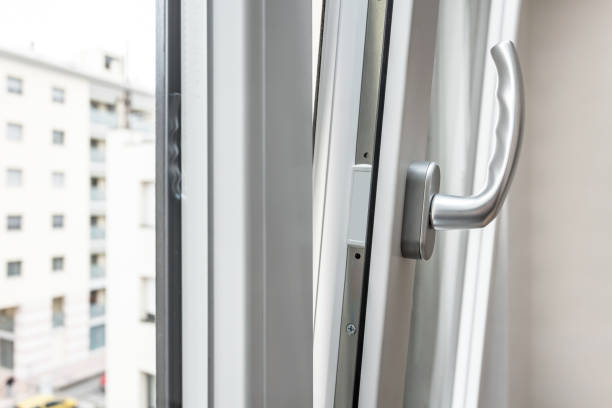 Aluminum window open detail. Bottom hung window. Metal, PVC door frame closeup view. Stylish chrome handle. Energy efficient and safety profile. Urban blurred background.