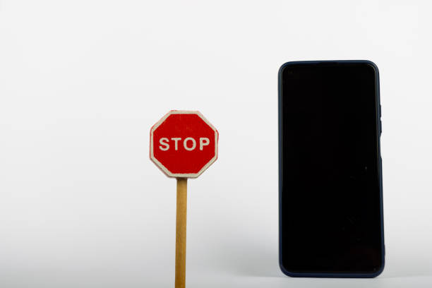 istock Wooden Stop Sign with Smartphone 2164323881