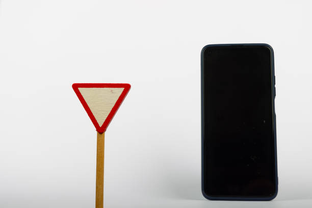 istock Wooden Yield Sign with Smartphone 2164323888