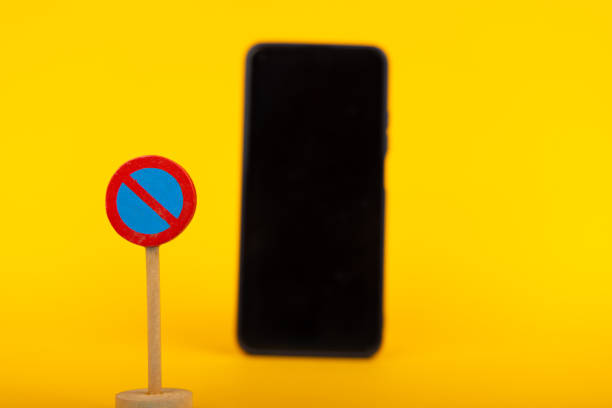 istock No Parking Sign and Blurred Smartphone 2164323971