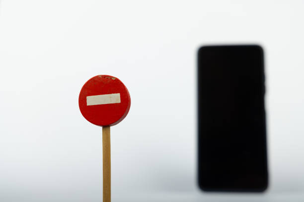 istock Toy No Entry Sign with Smartphone Background 2164324109
