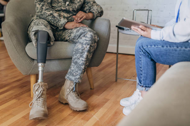 istock Camouflaged soldier with prosthetic leg during therapy session. 2164327949