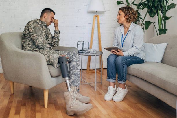 istock Discussion between soldier with prosthetic leg and counselor. 2164328248