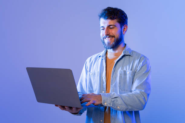 istock Man in Blue Shirt Using Laptop, Working Online 2164328304