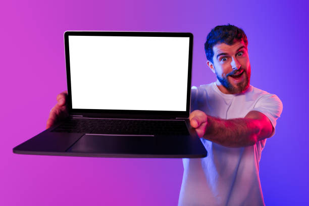 istock Excited Guy Showing Laptop With Blank Screen Over Neon Background 2164328332
