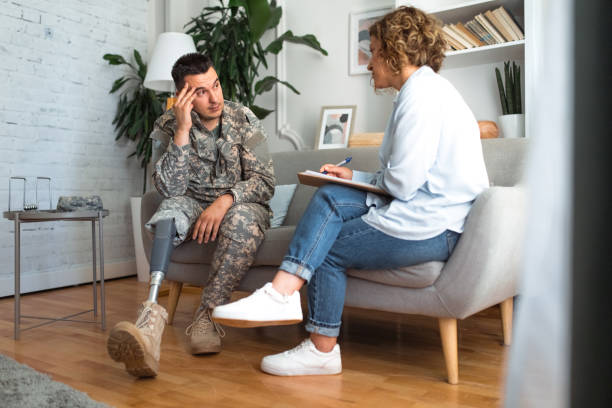 istock Distressed military man with a prosthetic leg in counseling session 2164328339