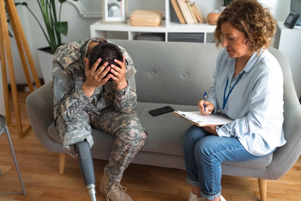 istock Distressed veteran with prosthetic leg during therapy 2164328539