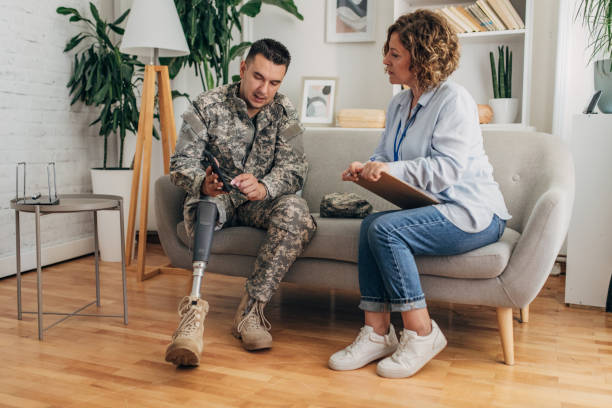 istock Military therapy session with counselor and prosthetic leg. 2164330051