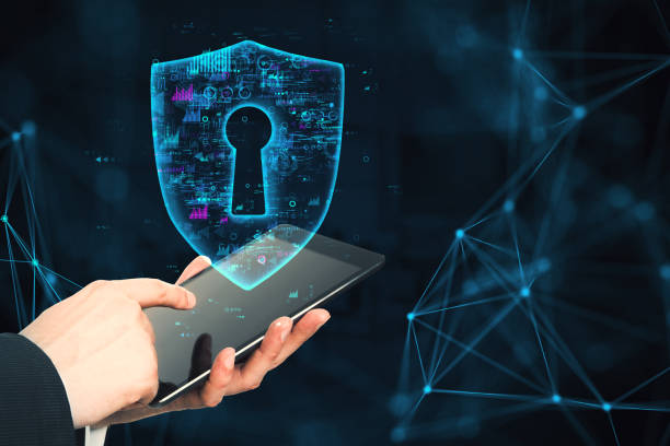 istock Digital security concept with a holographic shield and a tablet. 2164330606