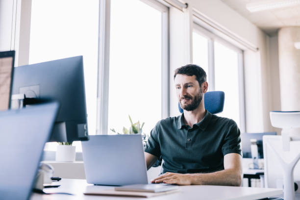 istock A businessman works on his laptop in a sleek office 2164330721