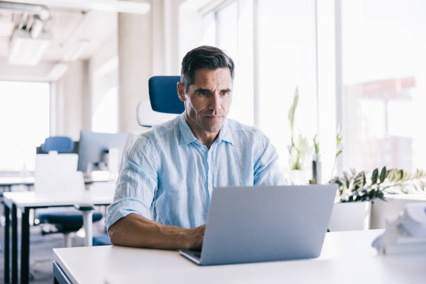istock Businessman working in a modern office space 2164330748