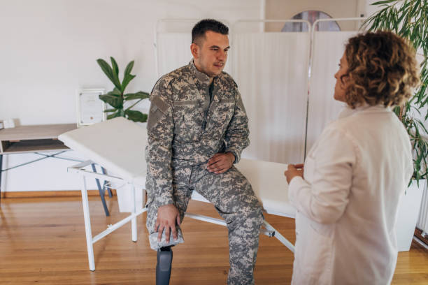 istock Soldier with prosthetic leg consulting with doctor. 2164331433