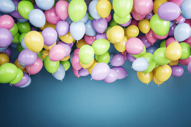 istock Colorful balloons floating against a blue wall backdrop. 3D Rendering 2164331476