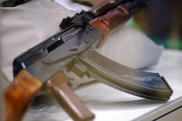istock Close-up of an assault rifle with wooden elements on display. Studio shot. 2164331696