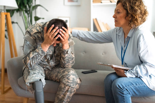 istock Therapist comforting distressed military veteran with a prosthetic leg 2164331949