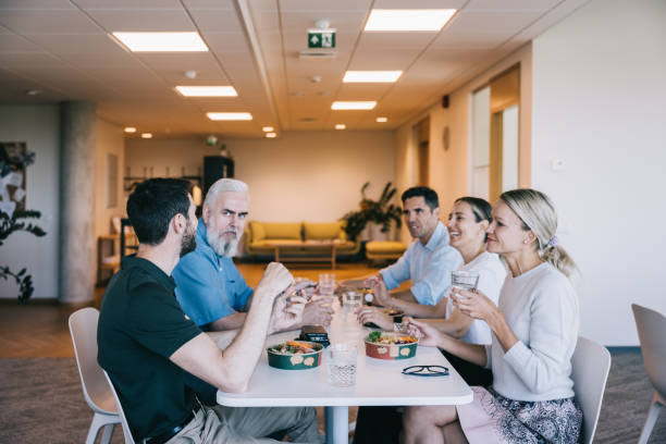 istock Colleagues enjoying lunch together in the office 2164332016