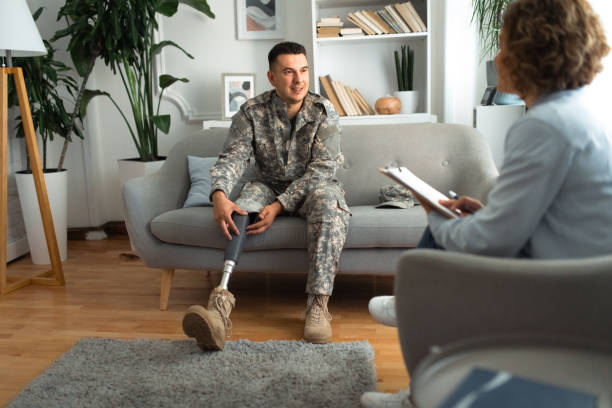 istock Therapist consulting a soldier with prosthetic leg. 2164332036