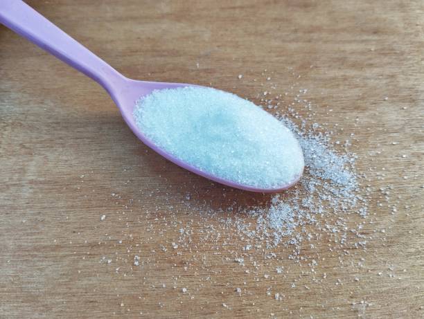 istock Sugar in spoon on the wooden table 2164332220