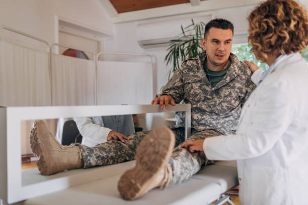 istock Veteran Amputee Receiving Phantom Pain Relief Through Mirror Therapy Administered by Doctor 2164332384
