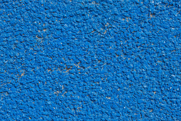 Close-up texture of blue rubberized surface with small granules. Abstract background for design and print