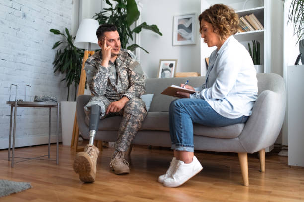 istock Veteran in therapy session with prosthetic leg and therapist 2164332606