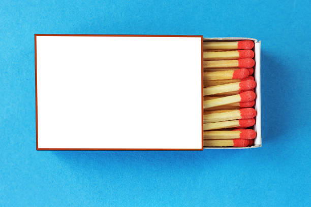 istock Matchbox with red matchheads on a blue background, top view 2164332749