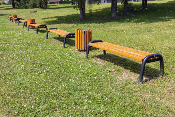 istock Benches and trash cans in the recreation park during the summer 2164332788