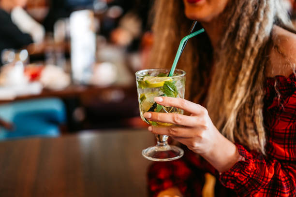 istock Young Woman Drinking Mojito Cocktail In A Bar 2164333224
