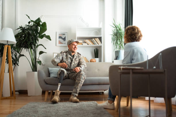 istock Veteran with prosthetic leg sitting and talking with a therapist 2164333358