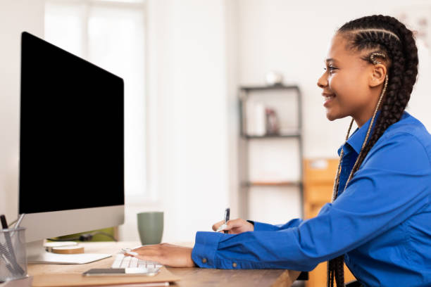 istock Focused female student engaged in online learning with computer at home 2164333745