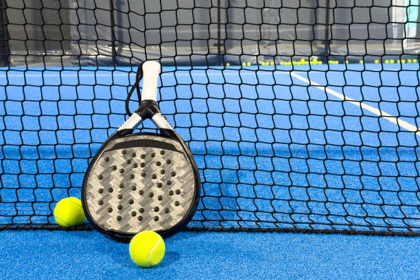 istock padel racket on a padel blue court with a ball 2164333799