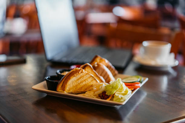 Club sandwich and dipping sauces on the table in the pub.