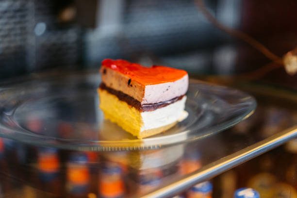 A slice of cake on a plate in a coffee shop.