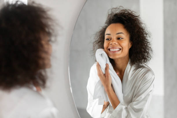 istock Black Lady Drying Clean Face With Soft Towel In Bathroom 2164336334