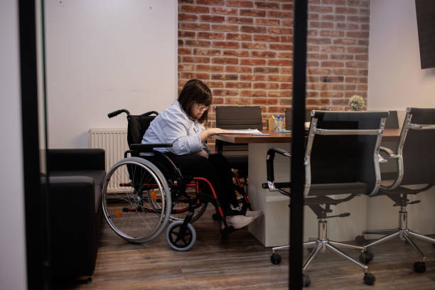 istock Woman with a disability working in an office 2164336515