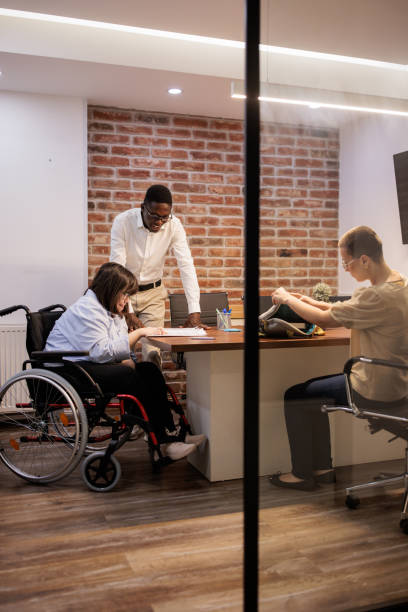 istock Coworkers talking in the office 2164336773