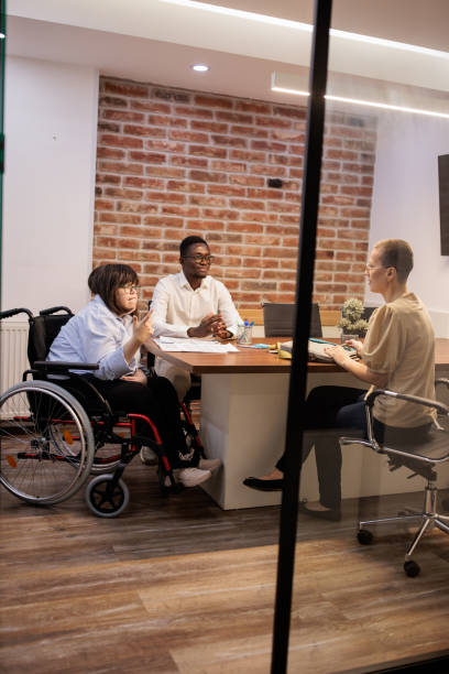 istock Coworkers talking in the office 2164336882
