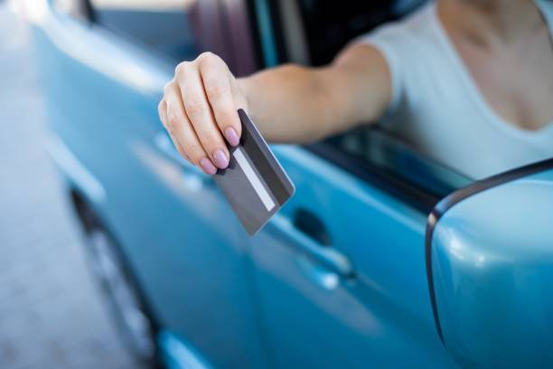 istock A woman pays with a credit card while refueling a car 2164337175