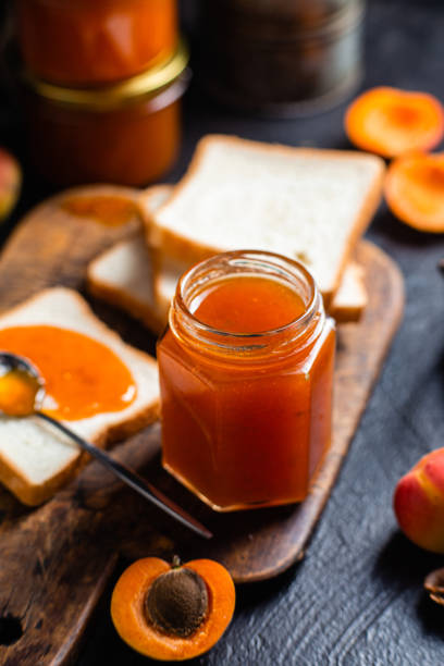 istock Ripe apricot jam in a glass jar on the table. 2164338033