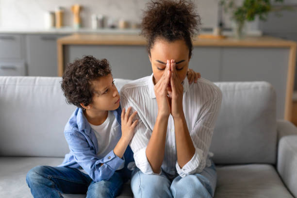 istock Concerned boy comforting stressed mother at home 2164339089