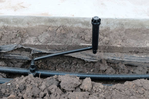 istock Sprinkler close-up, installation of automatic lawn watering system. 2164341251
