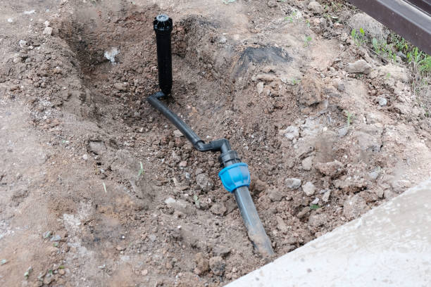 istock Sprinkler for automatic watering on a flexible connection close-up, the process of installing a pipeline from HDPE pipes 2164341294